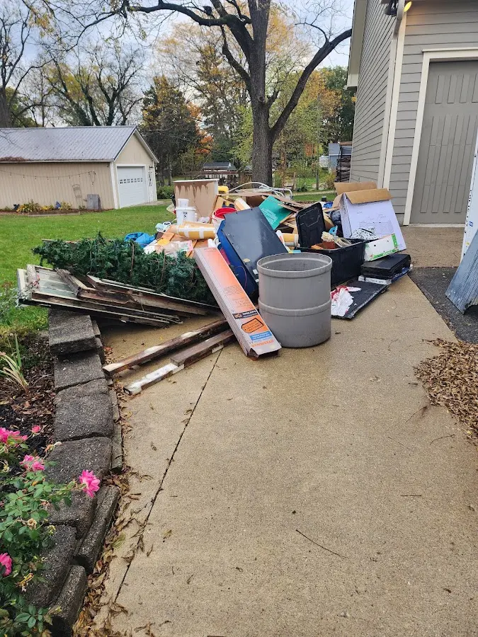 Dumpster being loaded with debris for 12 Yard Dumpster Rental in Montrose